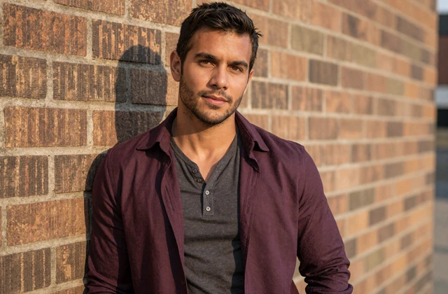 Calm confident man in charcoal henley representing the quiet-BDE male audience on StdDatingOnline